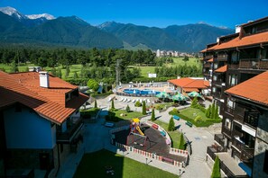 A hotel with a playground, a pool, and mountain views. - The Balkan Jewel Resort, Trademark Collection By W (Razlog)