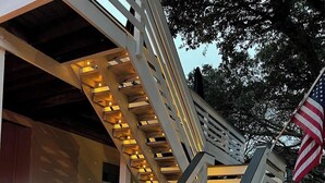 A staircase with illuminated handrails leading to a building. - Dog Friendly, Heated Pool, Hot Tub, 5Min to Beach! (Southern Shores)