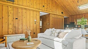 A cozy room with a white sofa, a wooden coffee table, and a radiator.