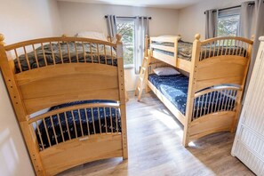 A room with two bunk beds, a window with curtains, and a white wardrobe. - Oceanside - Dog Friendly - Hot Tub (Kill Devil Hills)