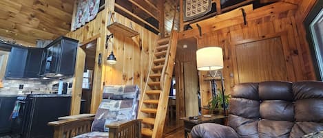 Stairs to the loft with queen + twin and a dedicated desk for remote work.