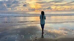 A person standing on a beach facing the ocean during sunset. - Dreamy Beachfront house with pool secluded miles beach Che Shale Malindi Kenya (Che shale Bay, Malindi)