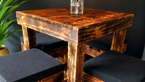 A round wooden table with two matching chairs, each with a cushioned seat. - Stylish Laureles Loft in Medellin (Medellín)