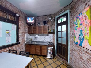 Full-size fridge, griddle, cleaning supplies, freezer