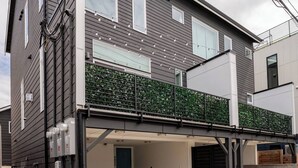 A modern two-story house with a covered parking area and a green garden on the upper floor. - West Seattle Junction • Private Parking • Walkable • 15 mins from Downtown (Seattle)