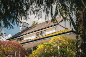 Un bâtiment à deux étages, doté d’un toit à pignon, d’une cheminée et d’un balcon.