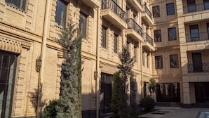 A multi-story building with a classic architectural style, featuring ornate balconies and large windows. - Meridian Plaza by Reikartz (Samarkand)