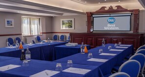 A conference room with tables, chairs, and a projector screen displaying 'BW Best Western.' - Best Western Glasgow Livingston Hilcroft Hotel (Bathgate)