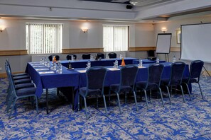 A conference room with a long table, chairs, water bottles, and a projector screen. - Best Western Glasgow Livingston Hilcroft Hotel (Bathgate)