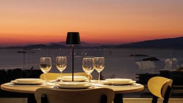 Enjoy meals with a view of the water and distant mountains from this dining table for four.