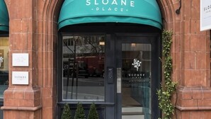 A building entrance with a sign reading 'SLOANE PLACE.' - Sloane Place (London)