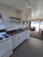 Family Apartment, Pool View | Private kitchen | Mini-fridge