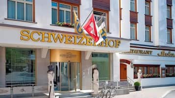 A hotel entrance with a sign reading 'SCHWEIZERHOF' and a flag.