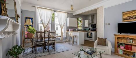 Relax in a cozy apartment with a comfortable sofa, dining area, and modern kitchen.