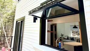 A two-story house with a sliding glass door and a deck.