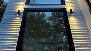 A modern building with three large windows and a flat roof.