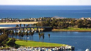 A marina with boats, a bridge, and a coastal cityscape.