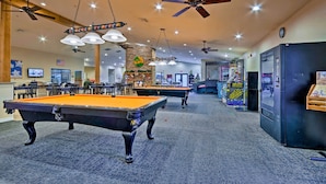 A pool table area with ceiling fans, a brick wall, and a vending machine. - Game & Movie Rooms! Unit 4 Mi to Branson Landing (Branson)