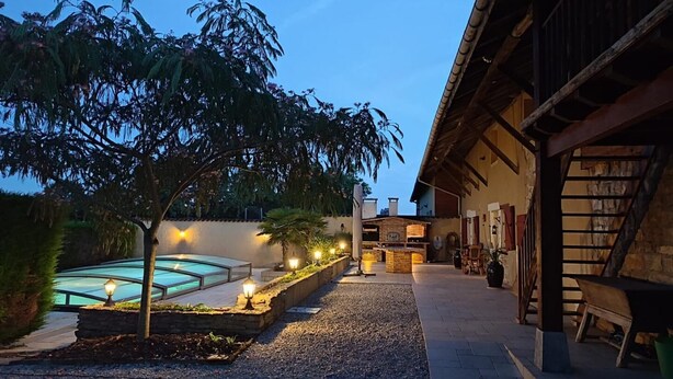A courtyard with a swimming pool, a bar area, and a staircase leading to a building. - Ain Amour de Bresse - DOMSURE (DOMSURE)