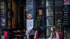 A restaurant with outdoor seating, a menu board, and a sign indicating a movie night event. - Archeo Cafe and Hostel (Istanbul)