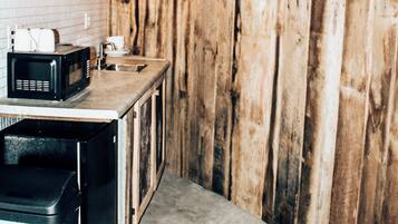 Fridge, microwave, coffee/tea maker, cookware/dishes/utensils