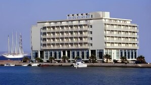 A modern hotel with multiple floors, large windows, and a waterfront view. - Chios Chandris (Chios)