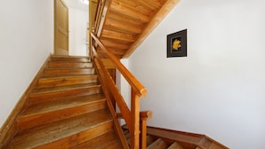 Un escalier en bois, doté d’une main courante, menant à l’étage supérieur.