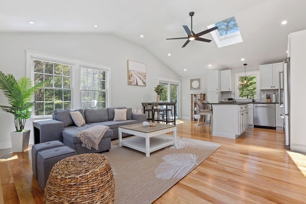 Seamless togetherness and personal space coexist in this inviting living room. From this vantage point, you can glimpse the kitchen and workstation, allowing family and friends to stay connected while attending to their individual activities.