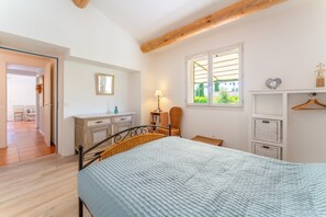 A bedroom with a bed, a dresser, a chair, a window, and a mirror. - Holiday Home “Lou Cigaloun” with Private Pool, Wi-Fi & Air Conditioning (Bédoin)