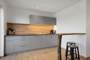 Fridge, stovetop, dishwasher, coffee/tea maker