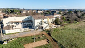 A large, multi-story building with a courtyard, surrounded by a rural landscape. - Holiday Home 'Mas Des Genêts' with Mountain View, Balcony and Wi-Fi (Laurac-en-Vivarais)