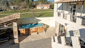 A two-story building with a swimming pool, outdoor seating, and a view of the surrounding landscape. - Holiday Home 'Mas Des Genêts' with Mountain View, Balcony and Wi-Fi (Laurac-en-Vivarais)