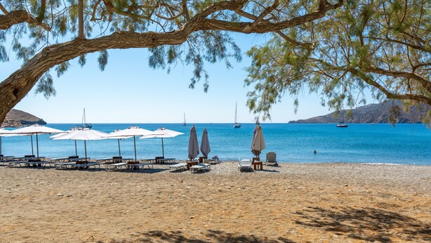 A beach with sun loungers and umbrellas, boats in the water, and a clear sky. - Apartment 'Salonikia Studio No 3' with Sea View, Wi-Fi and Air Conditioning (Astypalaia)