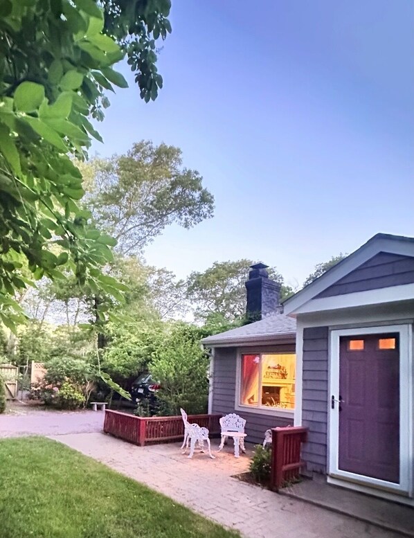 A house with a porch, a chimney, and a window with curtains. - Beach Pass Included! (Barnstable)