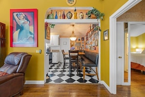 A dining area with a checkered floor, a bench, and a table with chairs. - Beach Pass Included! (Barnstable)