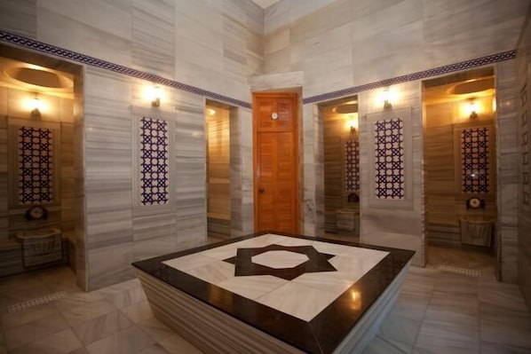 Welcome to our hotel lobby, featuring a large reception area with a geometric-patterned counter and a stylish tile design.
