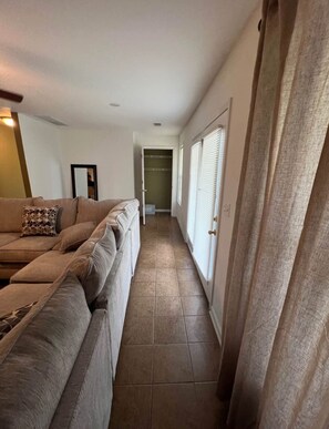 Enter a serene hallway leading to a cozy bedroom.