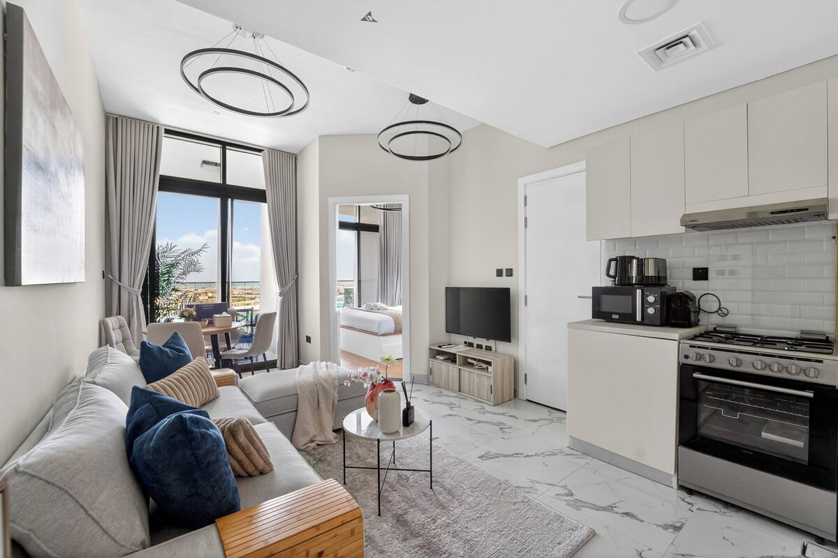 A modern living room with a sofa, coffee table, and a TV.