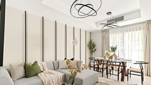 A modern living room with a sofa, coffee table, and dining area. - Silkhaus Springs 7 (Dubai)