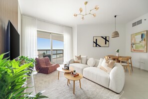 Signature Apartment | Living area | 50-inch Smart TV with digital channels - Silkhaus Ajwan C Tower (Abu Dhabi)