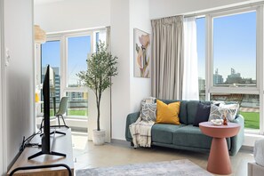 Club Studio, Balcony, City View | Living area | 50-inch Smart TV with digital channels