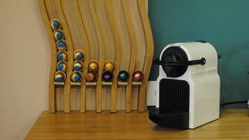 A coffee machine with a wooden stand holding various coffee pods.