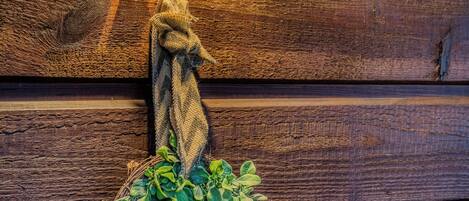 A wooden wall with a hexagonal lantern and a wreath.