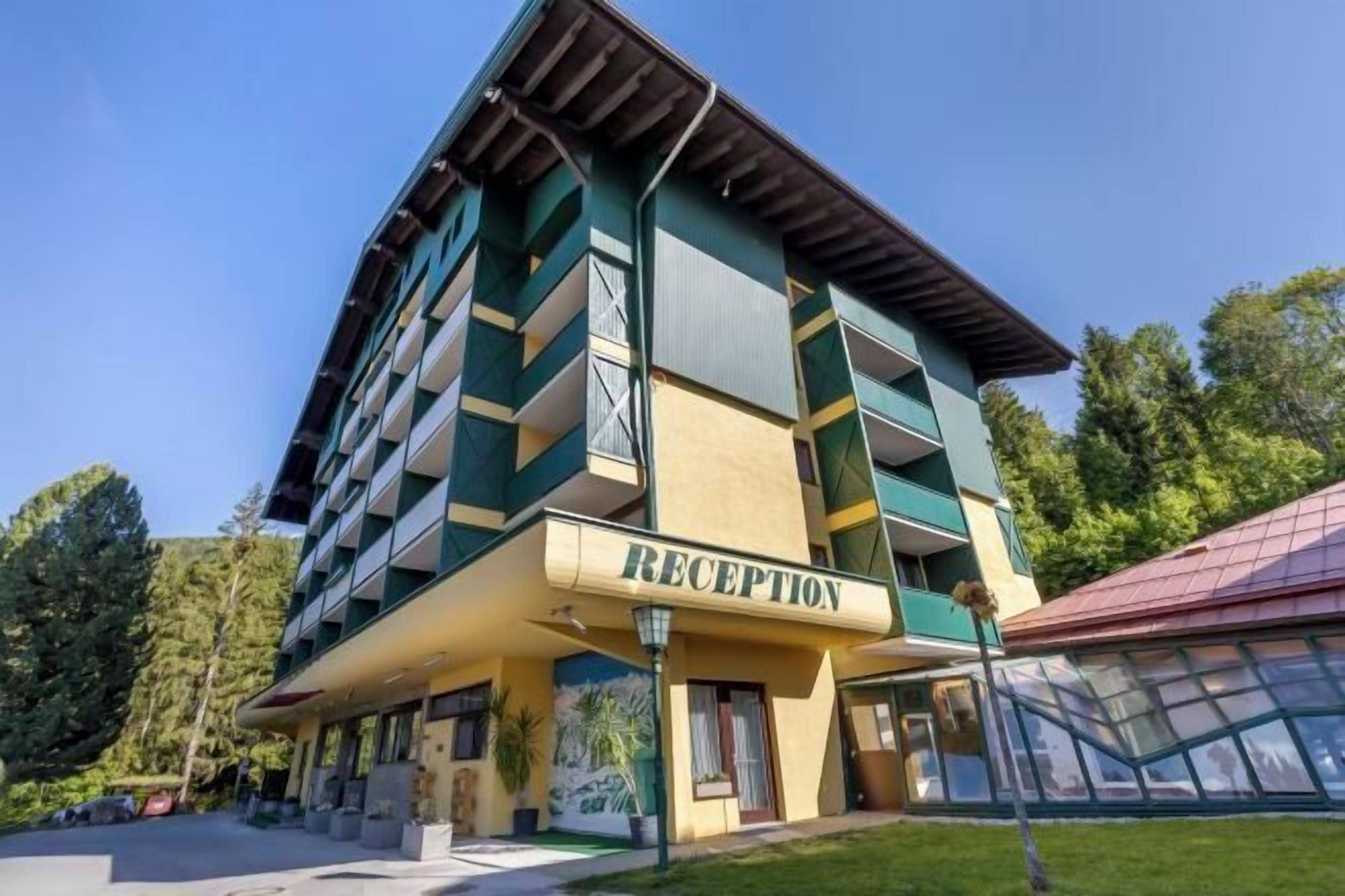 A multi-story hotel with a reception area labeled "RECEPTION" on the ground floor.