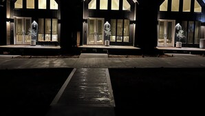 Three modern, dark-colored houses with large windows and a central pathway leading to the entrance. - IF Stay Collection is an exquisite and unexpected stand alone Row House. (Carriere)