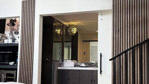 A modern interior with a bed, a dining area, and a kitchen. - IF Stay Collection is an exquisite and unexpected stand alone Row House. (Carriere)