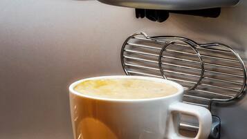 A coffee machine dispensing coffee into a white mug.