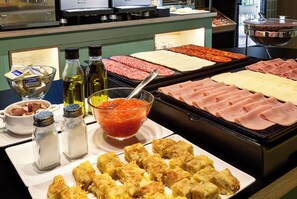 A buffet with various meats, cheeses, and condiments. - B&B Hotel Castellón (Castelló de la Plana)