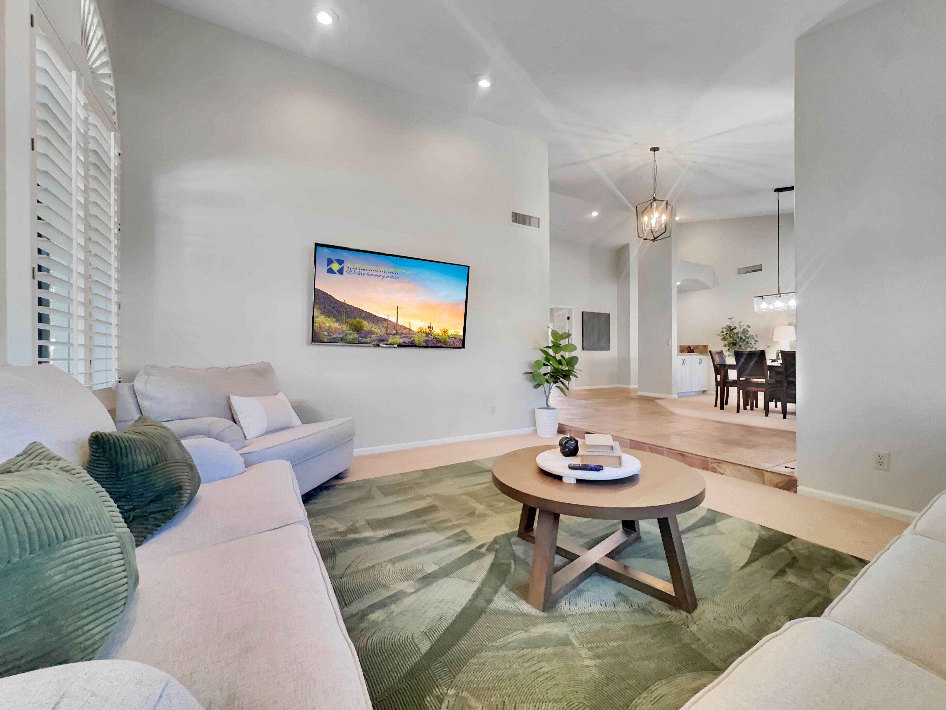 A modern living room with a sofa, a coffee table, and a painting on the wall.