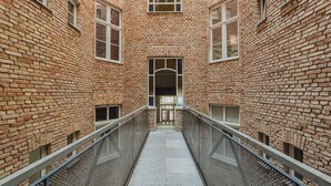 A brick building with a central staircase and a metal railing. - Wilson Park Loft Studio with Mezzanine (Poznań)